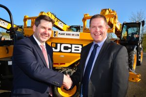 Sealing the deal: JCB UK & Ireland Sales Director Dan Thompstone (left) seals the deal with Plant Hire UK (PHUK) MD Graham Jones.